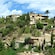 A lush hillside with several Spanish old houses